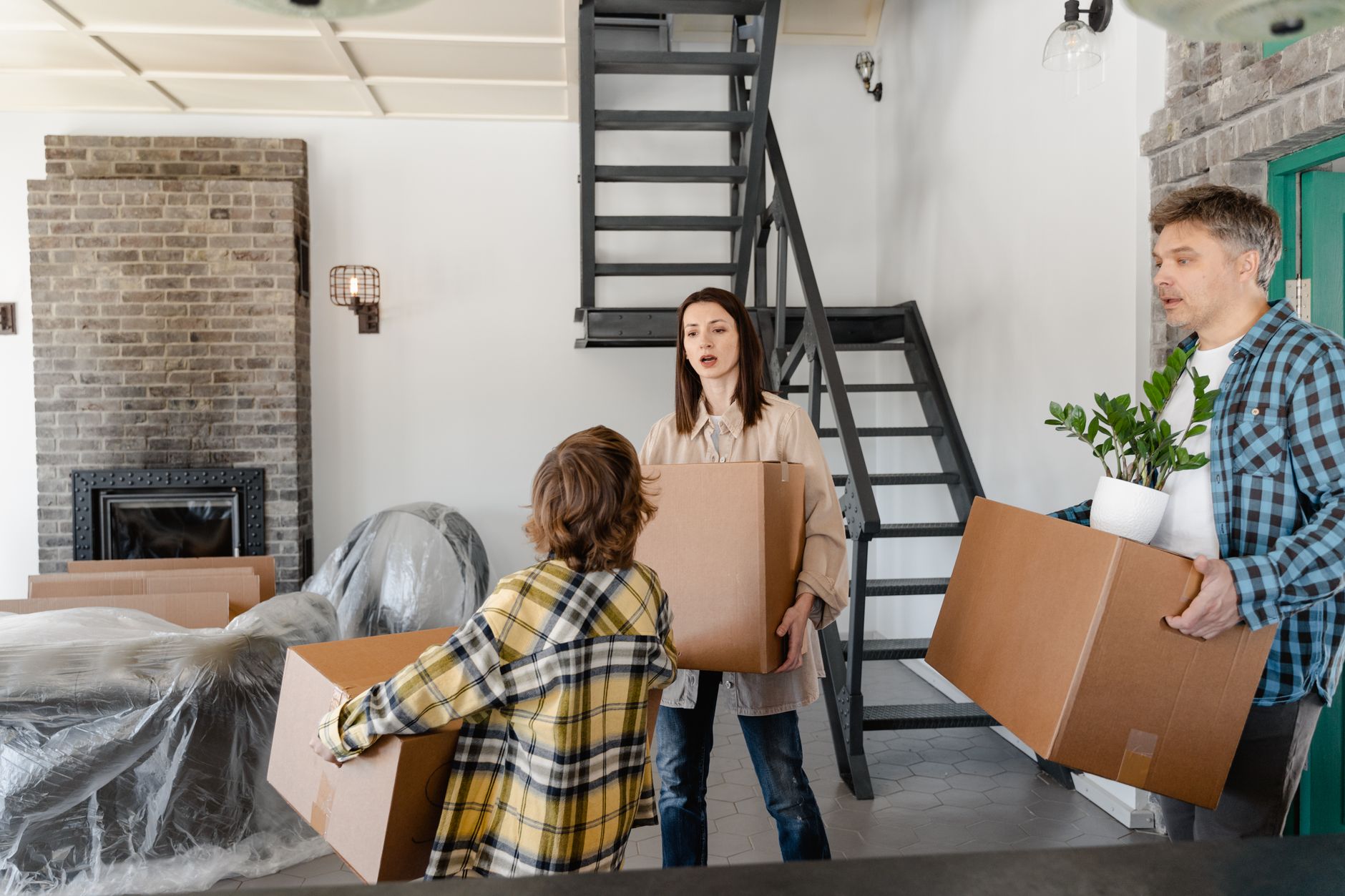 family looking at moving boxes in new home