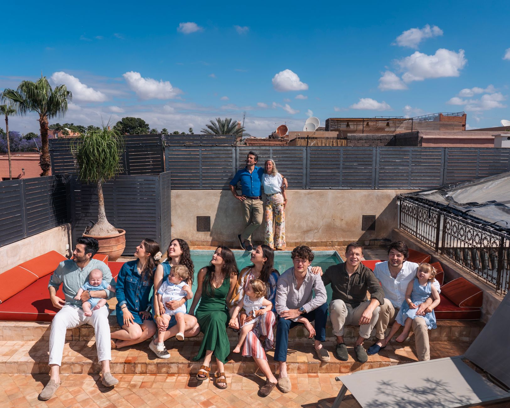 family relaxing in holiday rental on sunny terrace