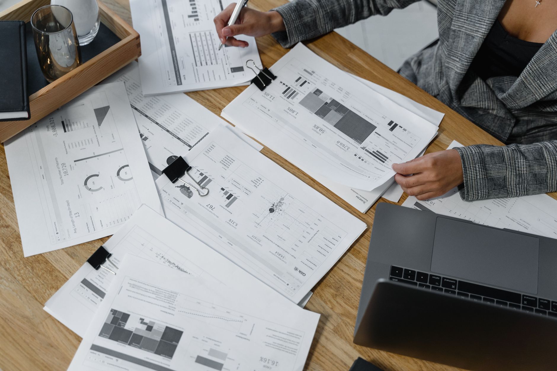 person reviewing financial documents on laptop