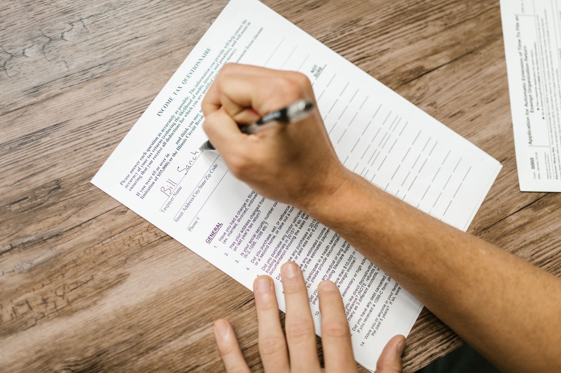person using laptop to fill out forms