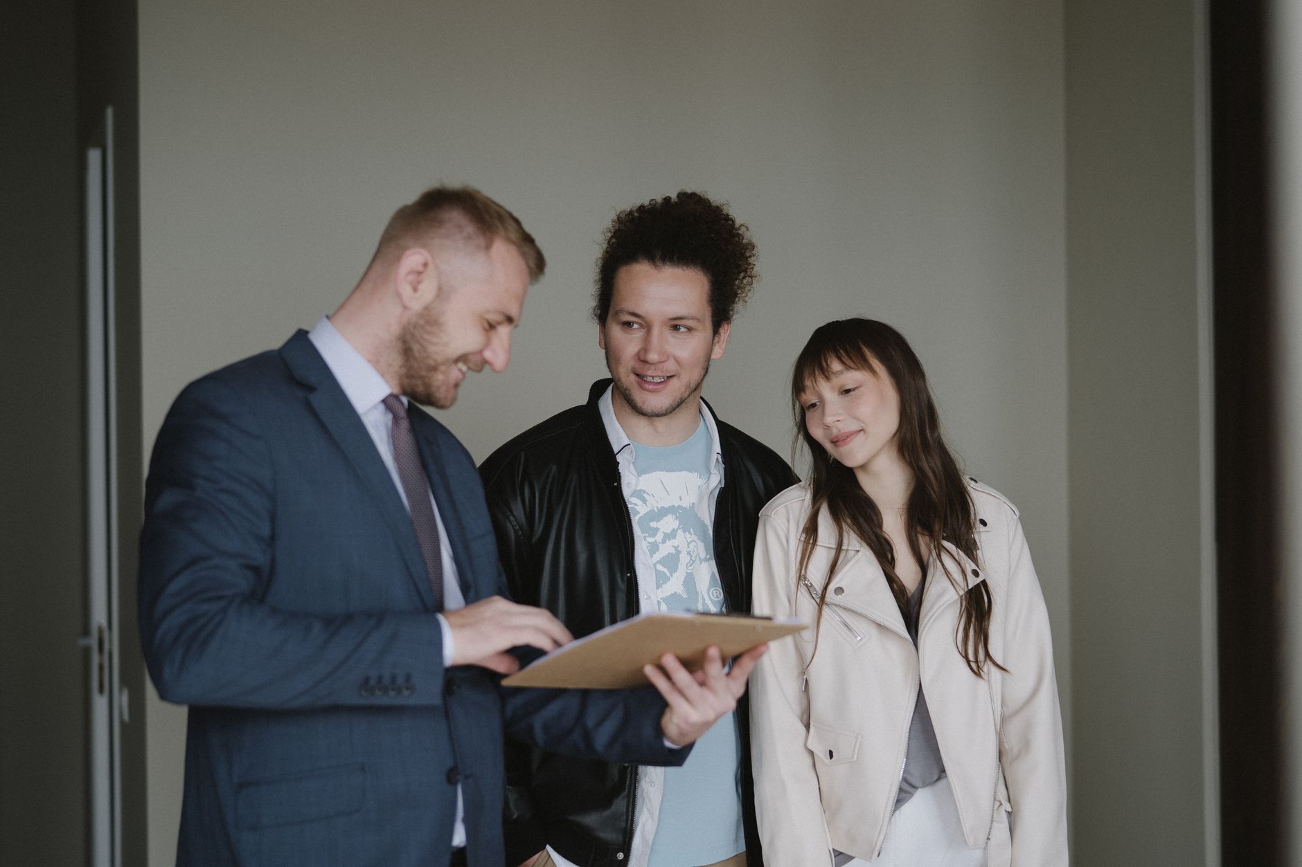 real estate agent showing apartment to couple