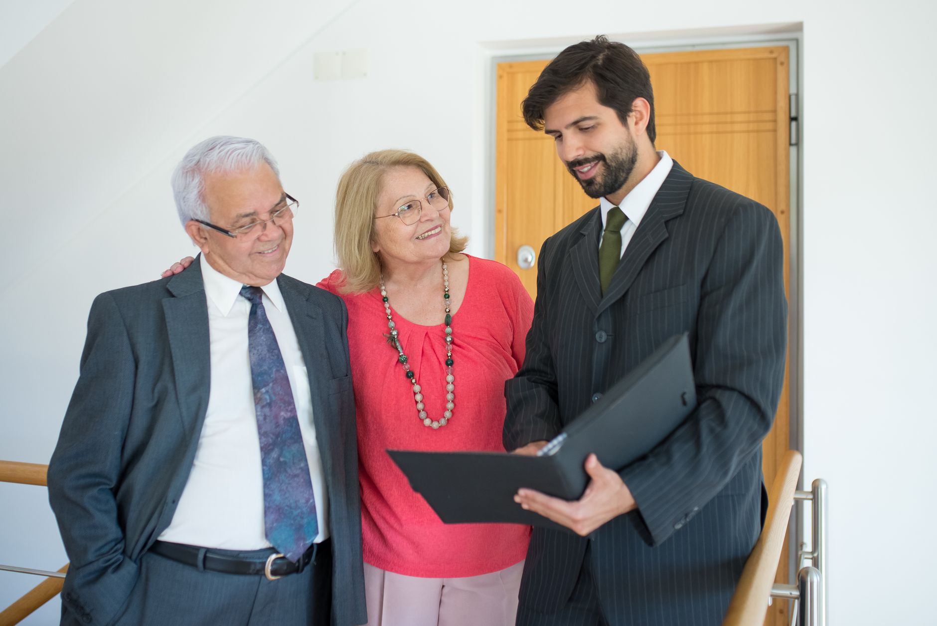 couple talking to real estate agent in office