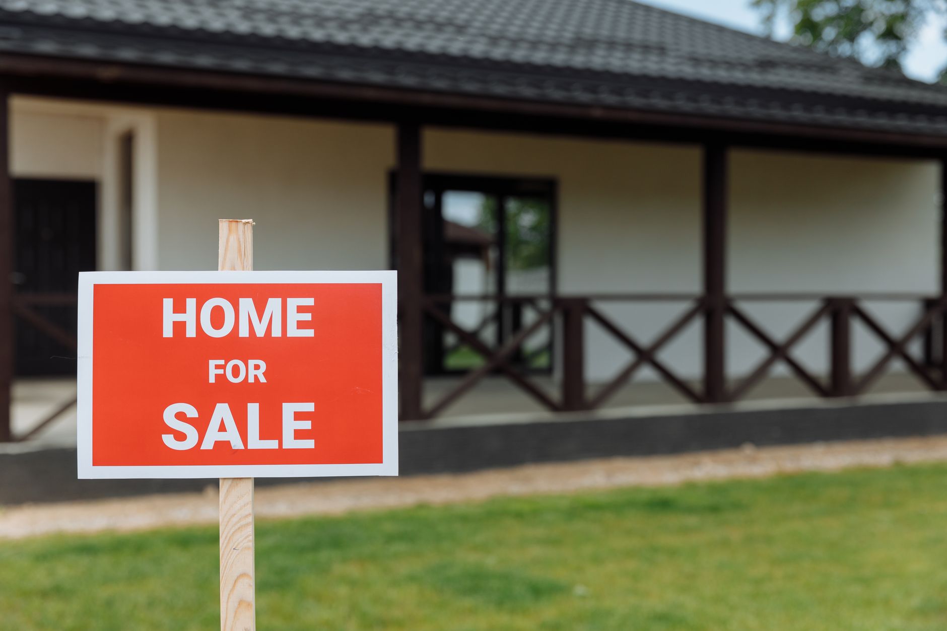 house for sale sign in front of modern home