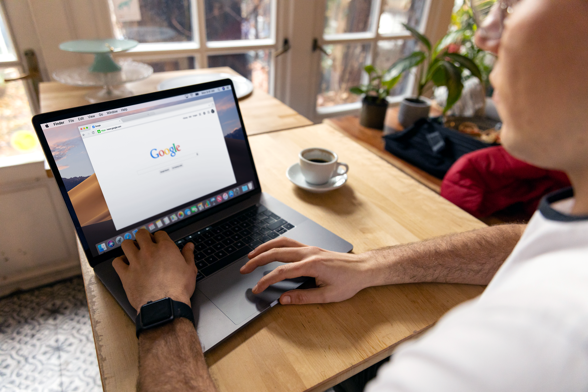 person searching house on laptop
