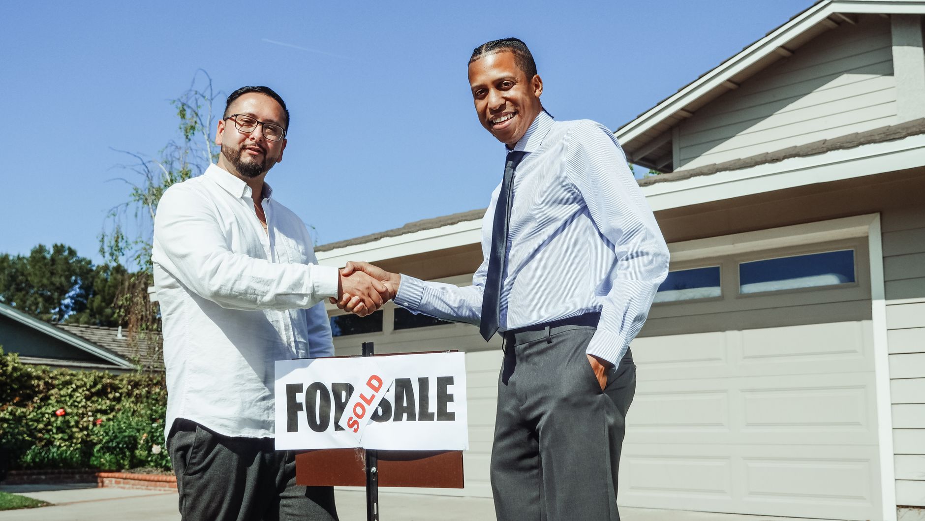 real estate agent shaking hands with client