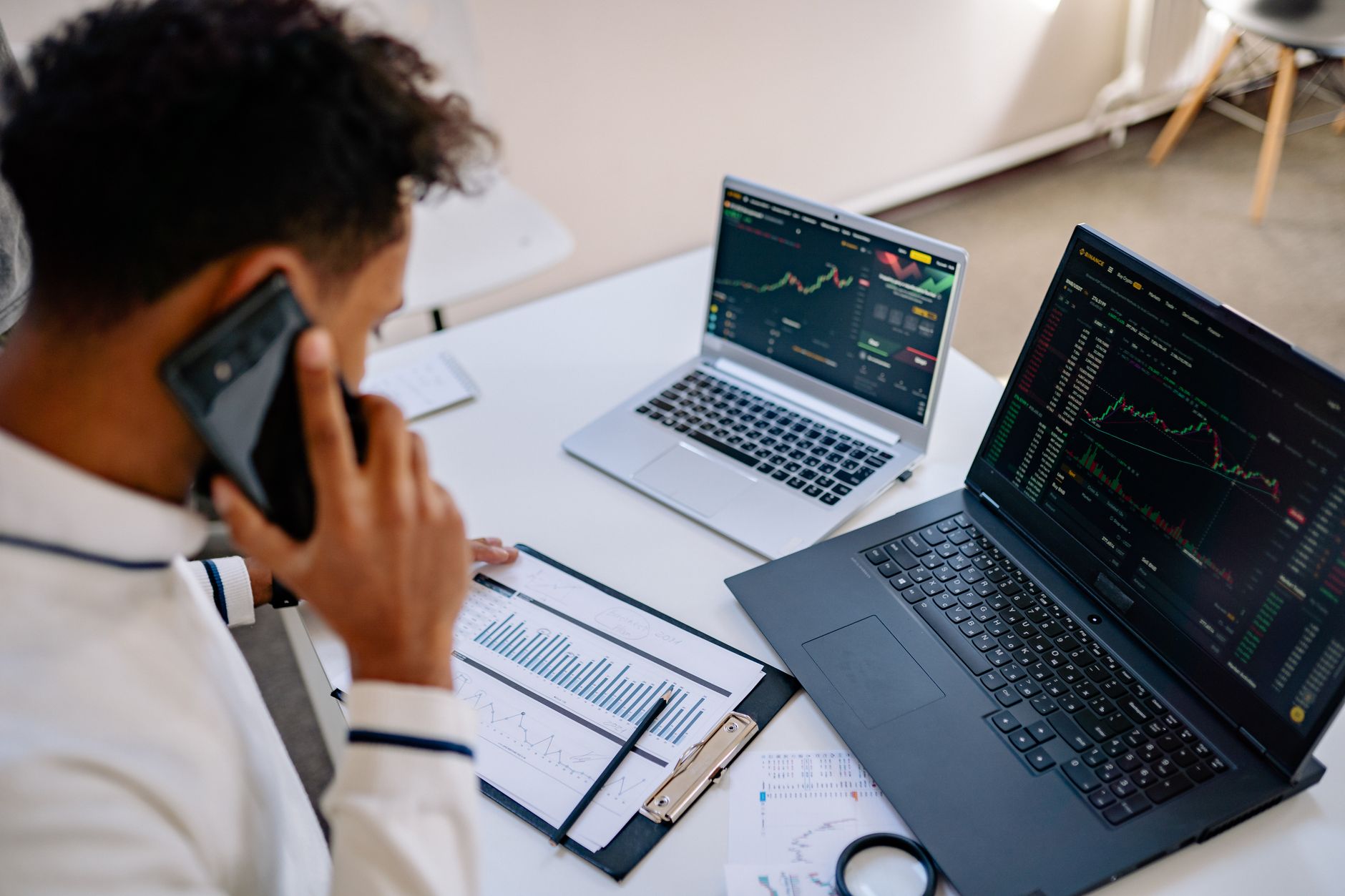 young person analyzing financial data on laptop